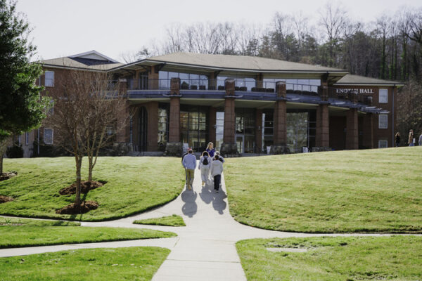 a group of people walking outside of a building