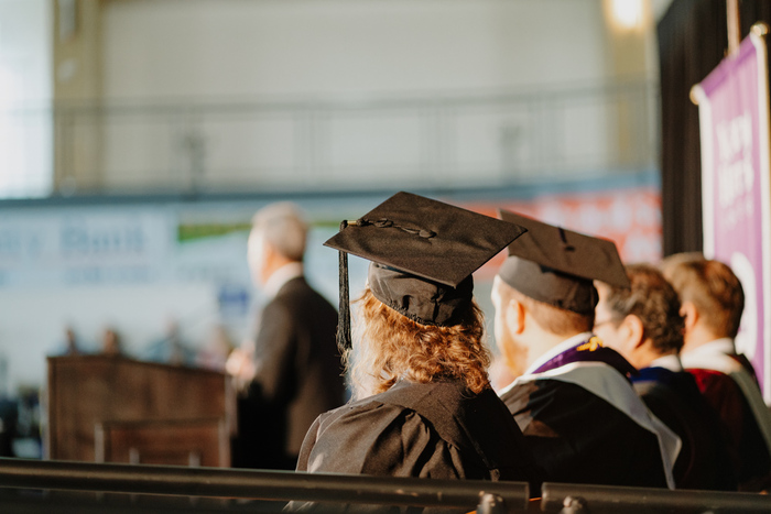 a man and a woman in graduation gowns
