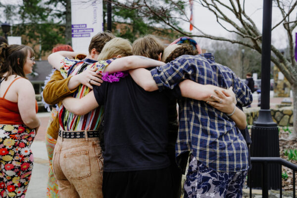 a group of people holding each other