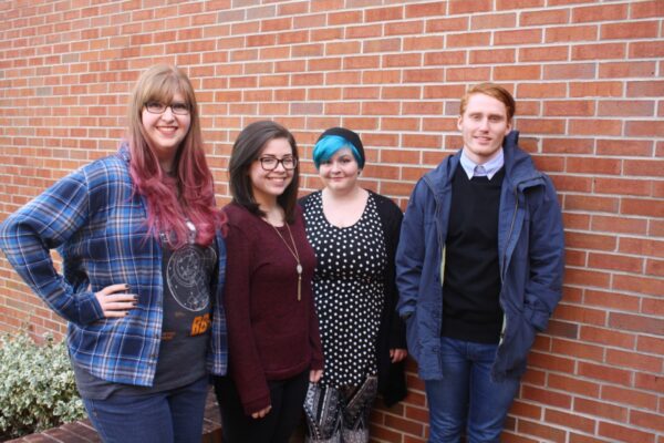 Students in front of brick wall