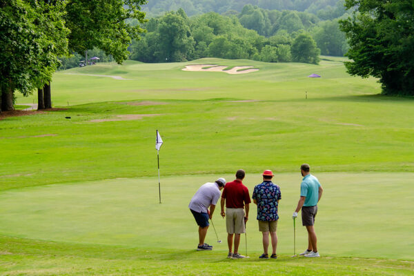 a group of men playing golf