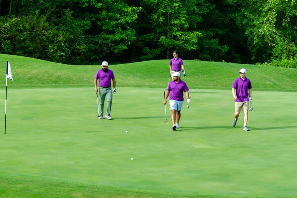 a group of people on a golf course