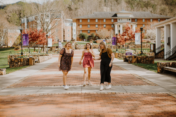 a group of women walking on a street