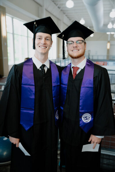 a couple of men in graduation gowns