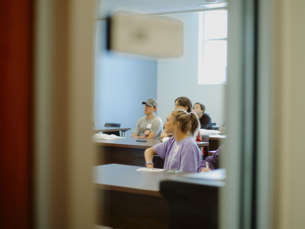 a group of people sitting at a desk