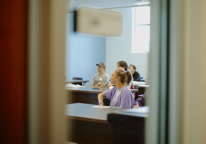 a group of people sitting at a desk