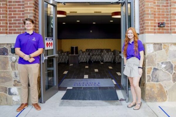 a couple of women standing in a doorway of a building