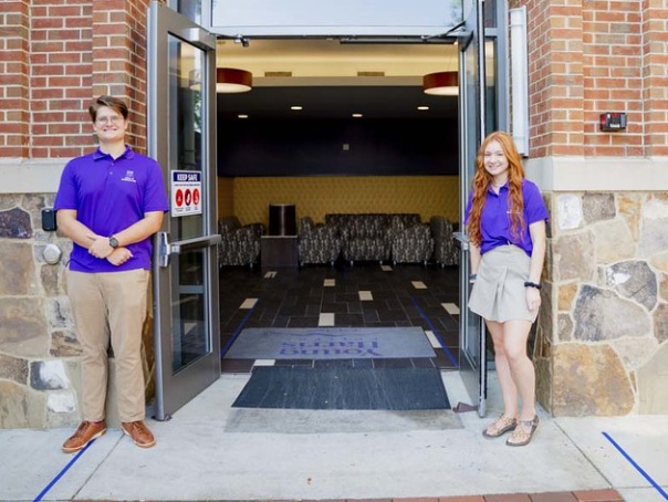 a couple of women standing in a doorway of a building