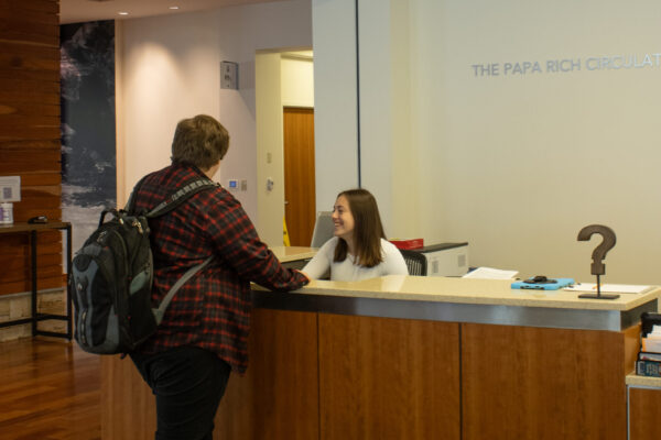 Student at service desk in library