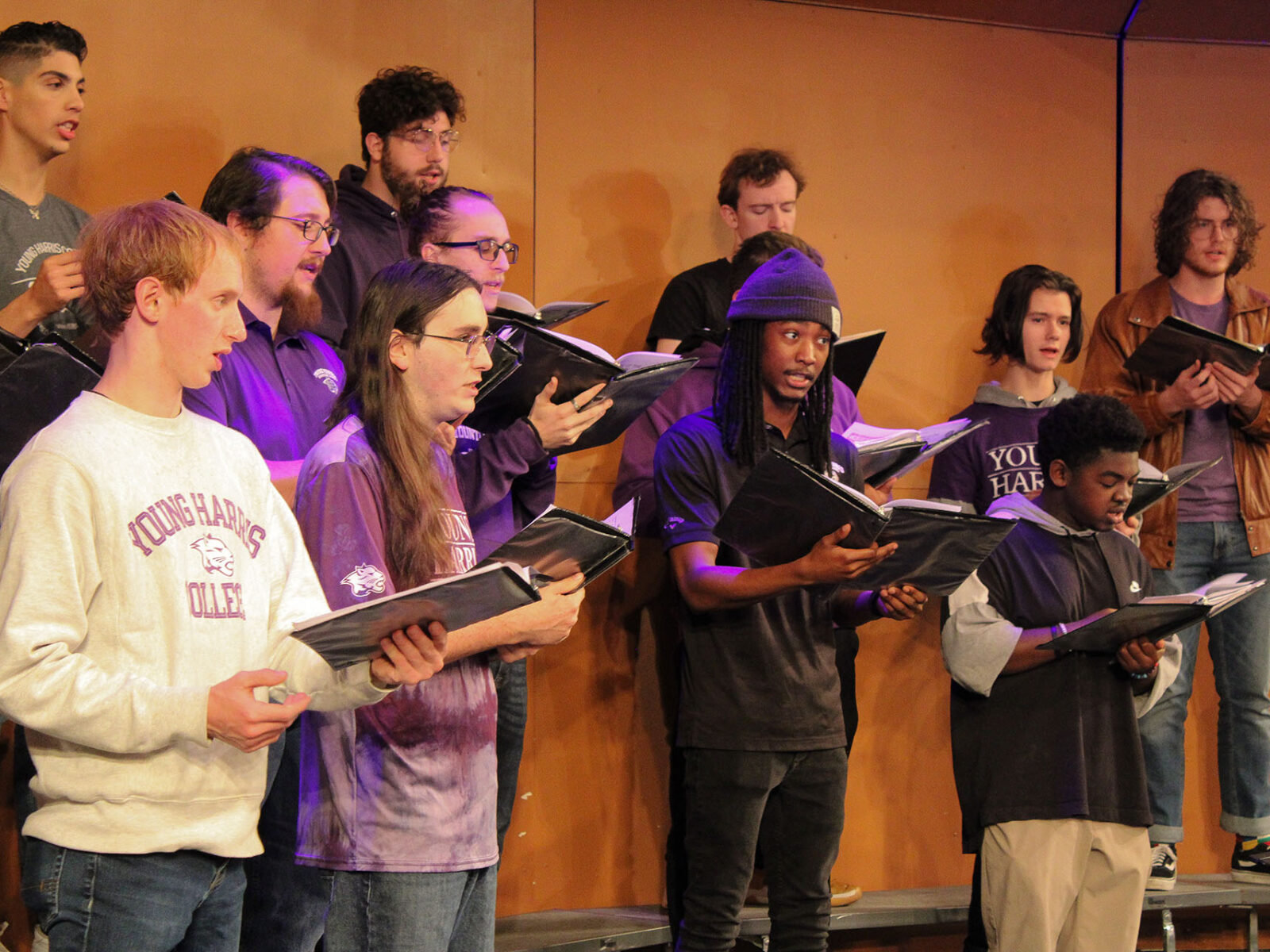 a group of people singing on stage