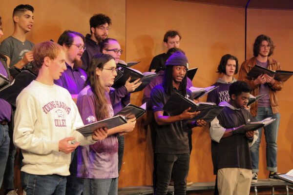 a group of people singing on stage