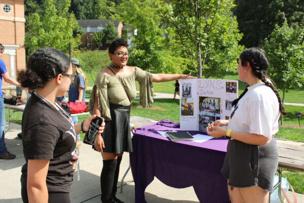 a person pointing to a poster