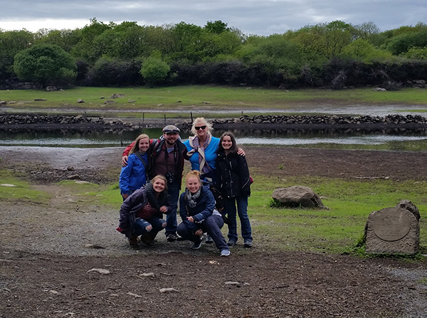 group posing front of lake