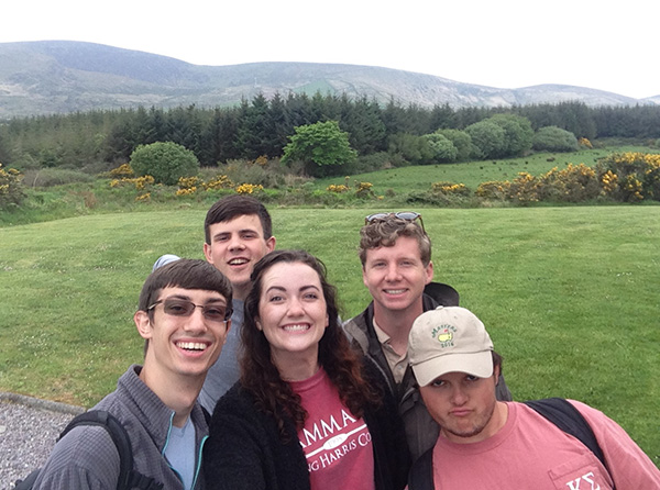 group of people posing for selfie