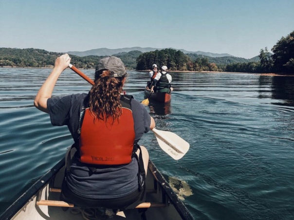 a group of people paddling on boats