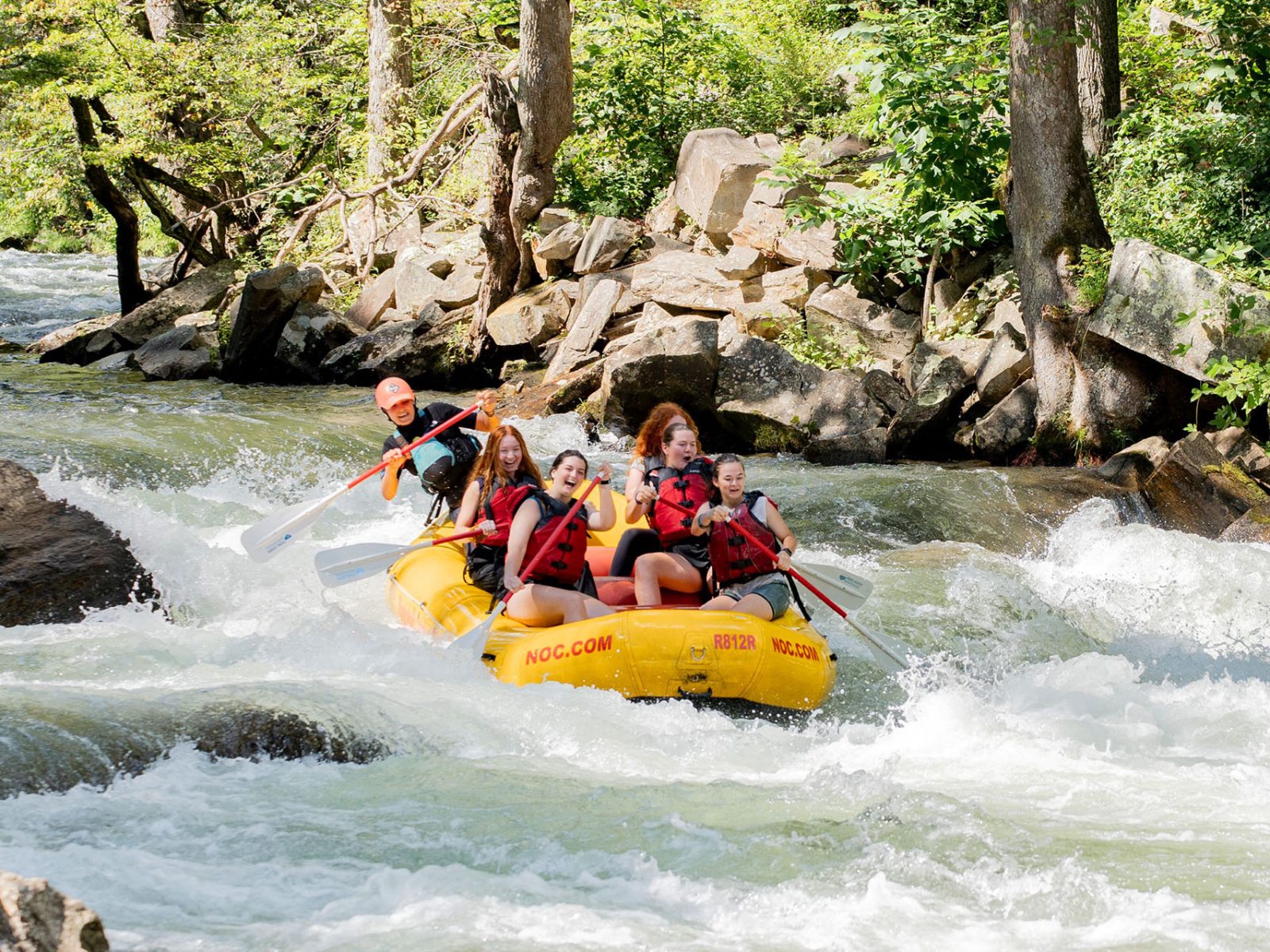 a group of people in a raft on a river