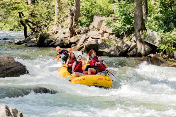 a group of people in a raft on a river