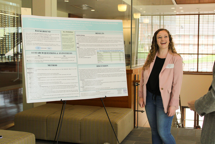 a person standing next to a large white board