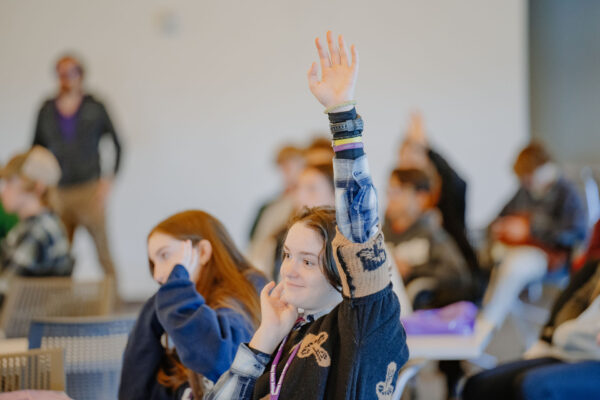 a group of people raising their hands