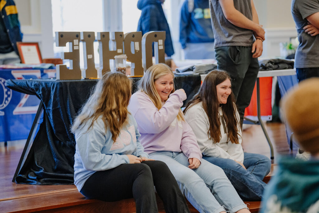 a group of women sitting on a bench