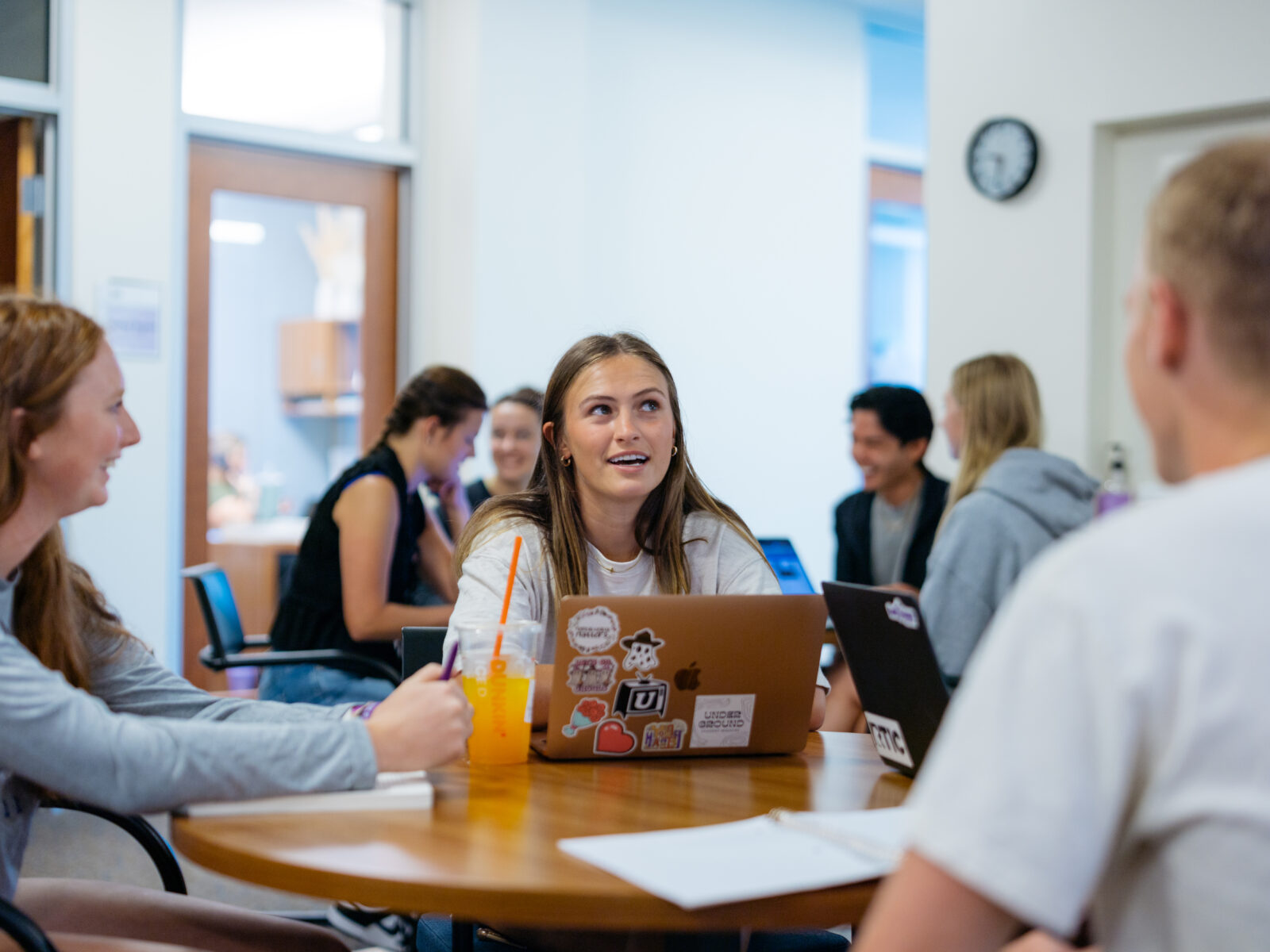 Students at table with laptop