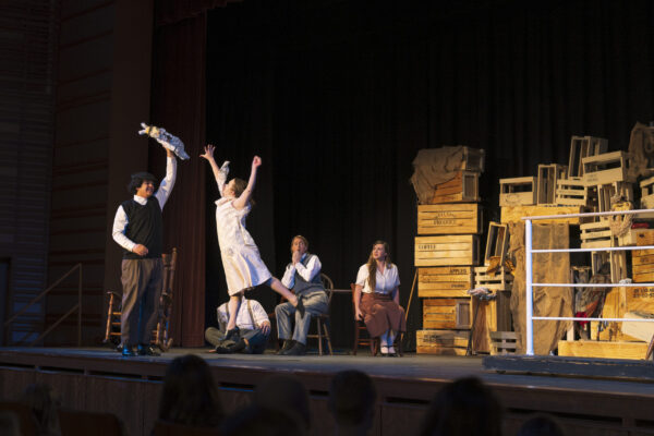 Photo of students on stage performing play