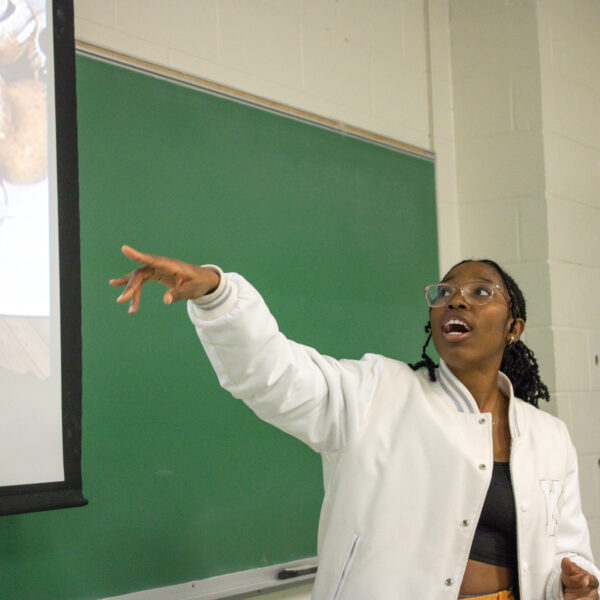 Tracy Dumakor pointing at a presentation