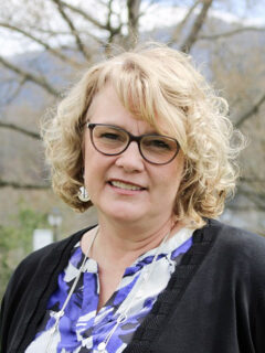 a person with blonde hair wearing glasses