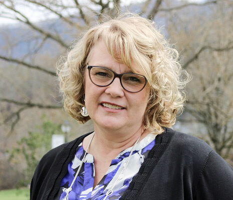 a person with blonde hair wearing glasses