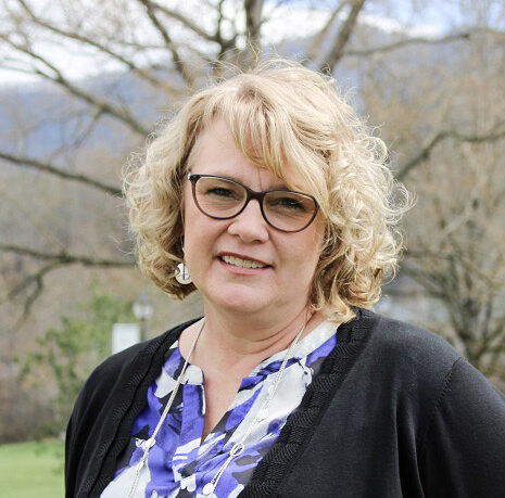 a person with blonde hair wearing glasses
