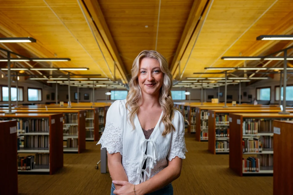 Young Harris College female student standing in library