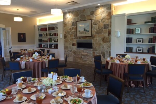 a room with tables and chairs with food on them