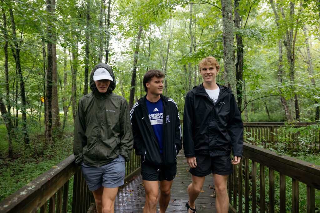 male students enjoy a walk on outdoor trails