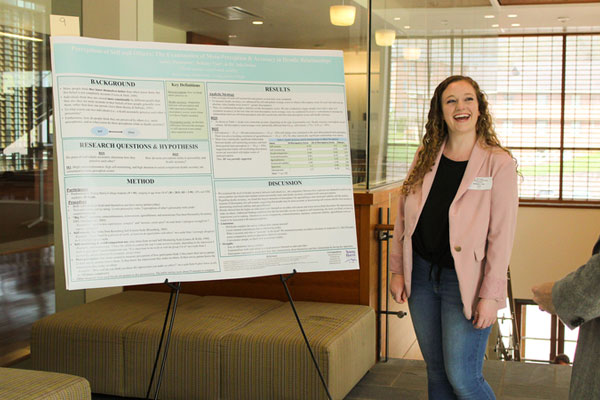 YHC student with presentation board